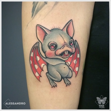 Fotografia di un braccio femminile con tatuato un pipistrello con ali a pois colorato, in stile new school/cartoon, realizzato da Alessandro Paparella presso lo studio Maia tattoo di cornaredo MIlano